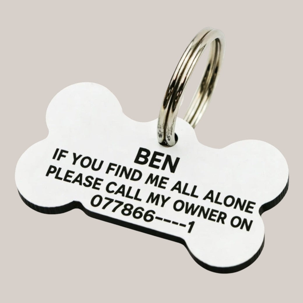 Bone‑shaped engraved dog tag — Aluminium bone‑shaped dog tag engraved with a pet’s name, available in multiple colours for dog collars.