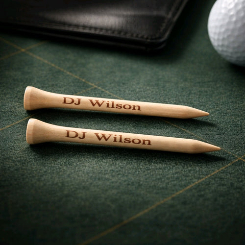 Personalised engraved golf tees — Close‑up of wooden golf tees with custom laser‑engraved names or messages.