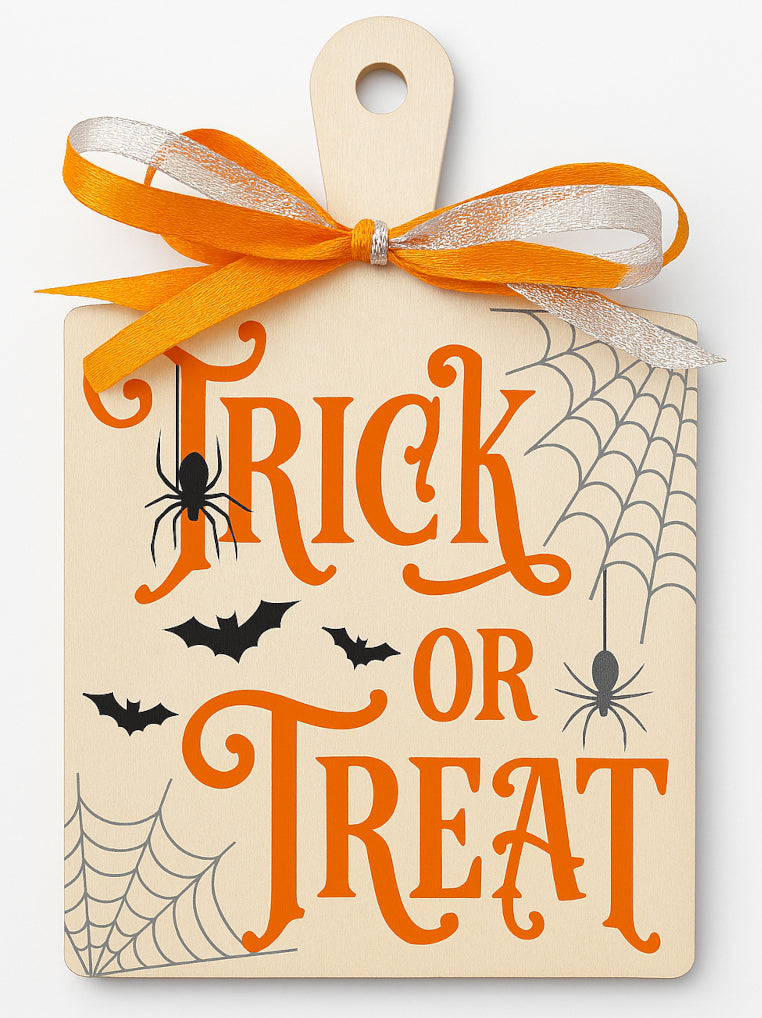 Halloween paddle board sign with vinyl graphics — Wooden paddle board decorated with bright orange vinyl bats, spiders and webs, displaying a “Trick or Treaters Welcome” message for hanging on doors, gates or porches.