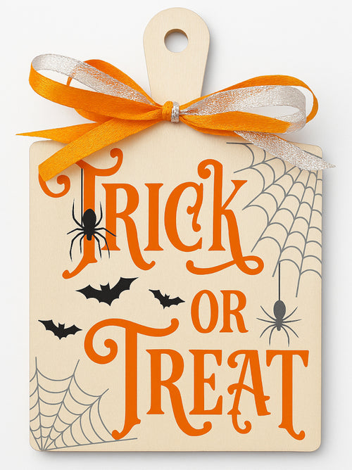 Halloween paddle board sign with vinyl graphics — Wooden paddle board decorated with bright orange vinyl bats, spiders and webs, displaying a “Trick or Treaters Welcome” message for hanging on doors, gates or porches.